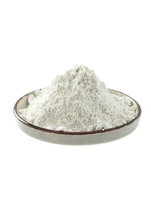 Fine-textured, pale grey bentonite clay heaped in a ceramic bowl