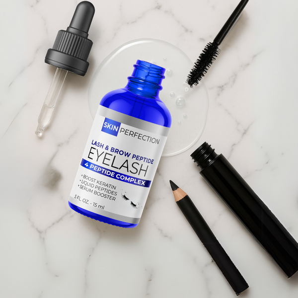 Eyelash serum bottle with applicator, pencil, and mascara on a marble surface