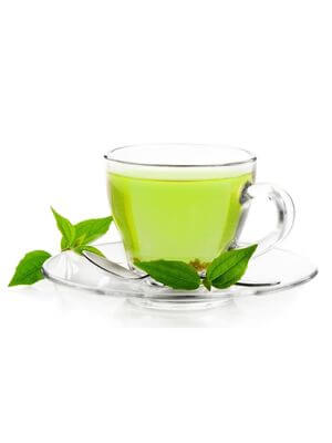 Clear glass cup of green tea with fresh green leaves on the saucer