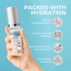 Hand holding a skincare serum bottle with hydration benefits on a blue background